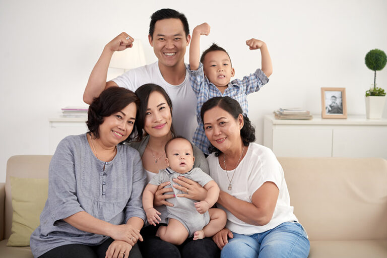 asian-extended-family-with-baby-toddler-posing-together-around-couch-home.jpg