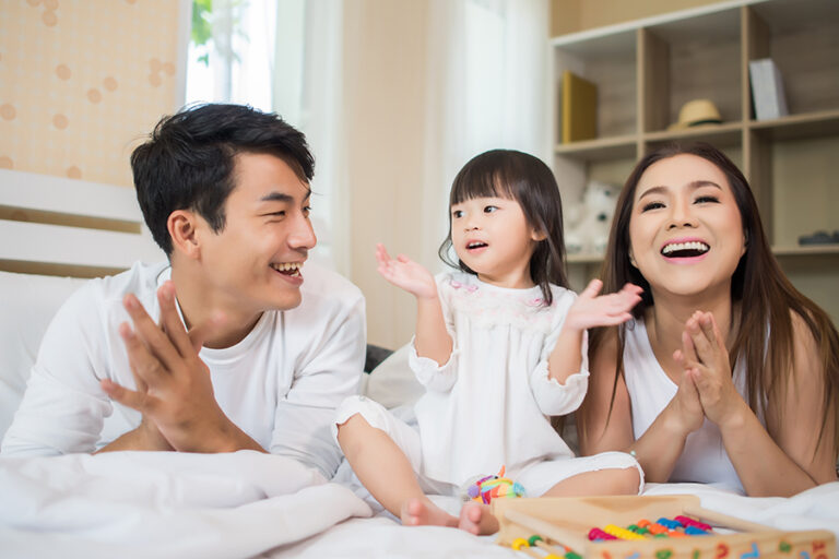 happy-child-with-parents-playing-bed-home.jpg
